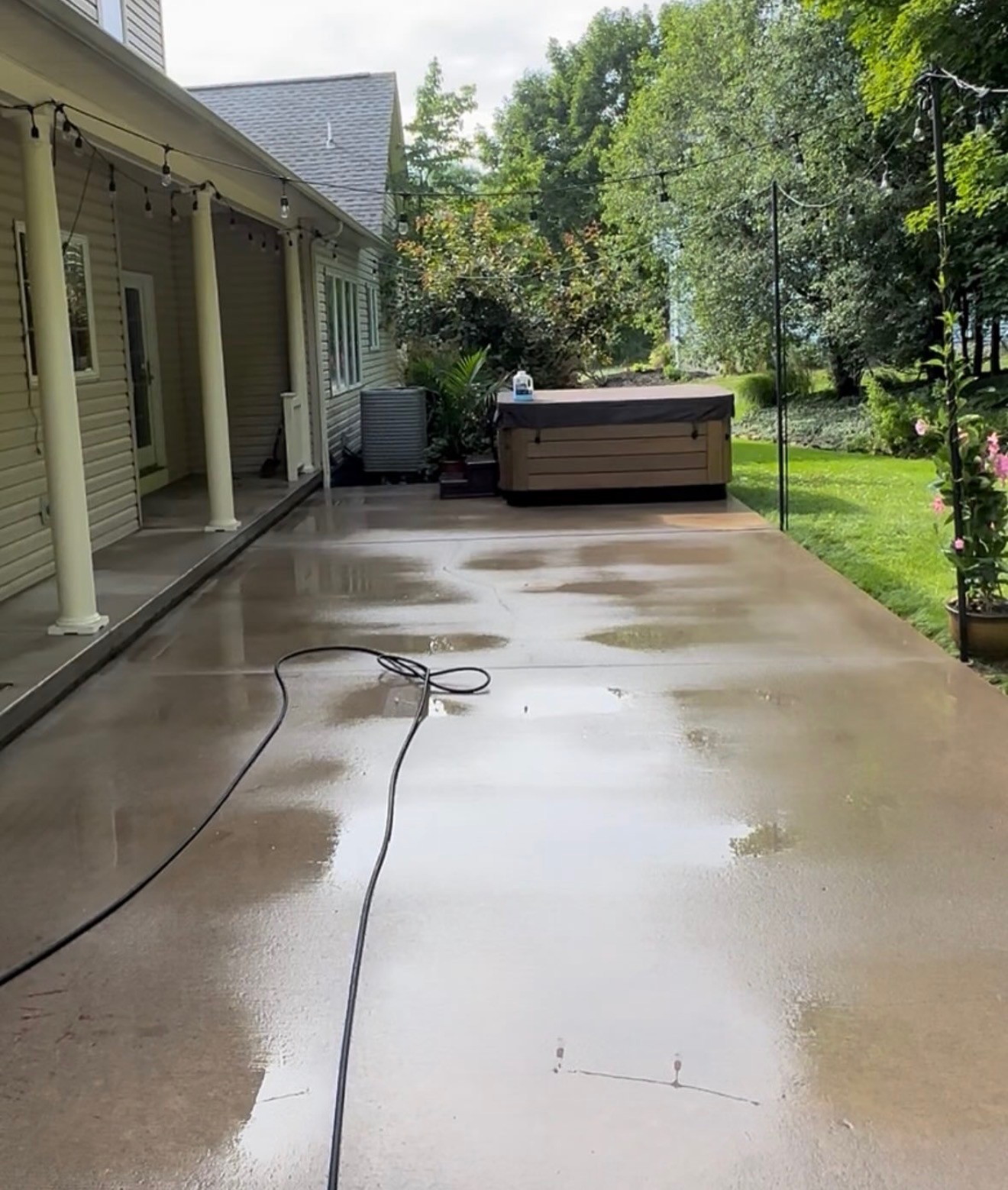 Freshly rinsed concrete patio after cleaning